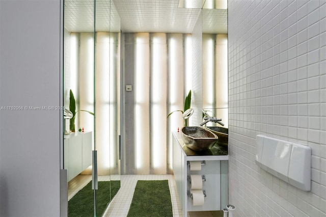 bathroom featuring vanity, tile walls, and tile patterned floors