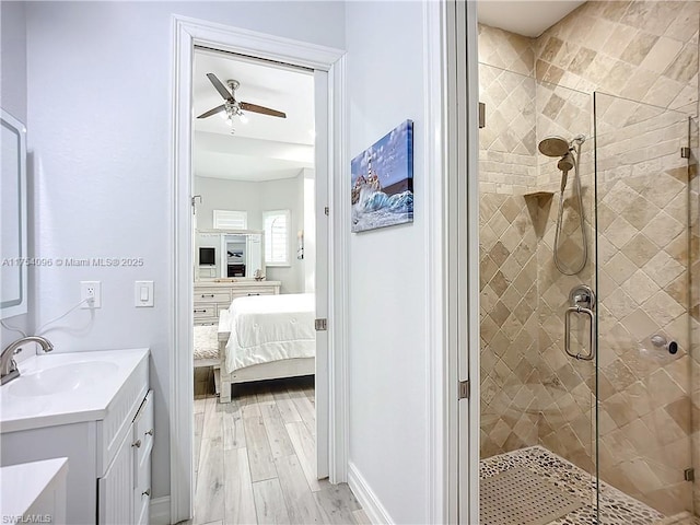 7684 County Rd 78, La Belle, FL 33935 - full bathroom with wood finished floors, a shower stall, vanity, and connected bathroom