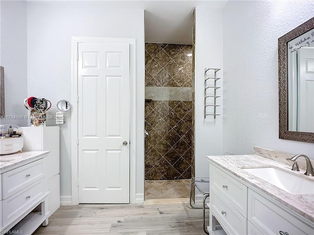 7684 County Rd 78, La Belle, FL 33935 - full bathroom featuring a walk in shower, wood finished floors, and vanity