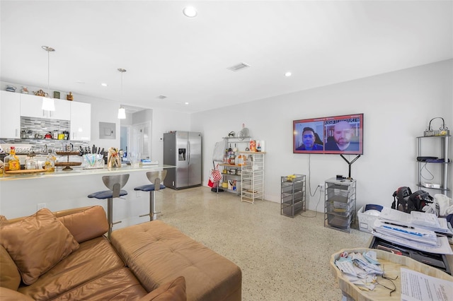 living room featuring light speckled floor, recessed lighting, and visible vents