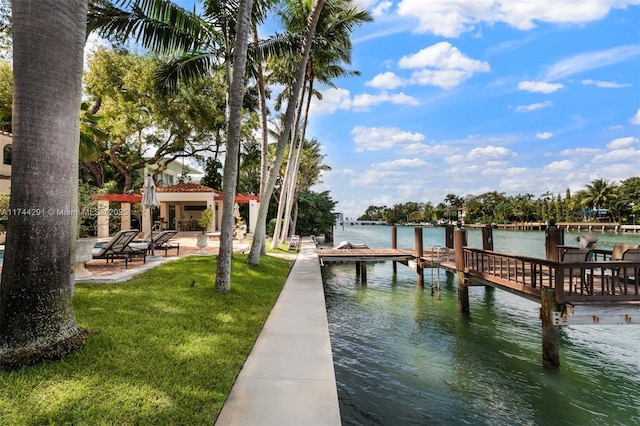 dock area with a water view and a yard