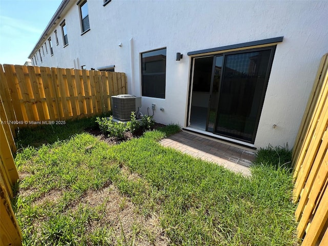 view of yard with cooling unit and fence