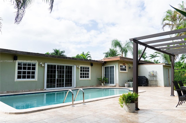 pool with a patio area, a pergola, and area for grilling