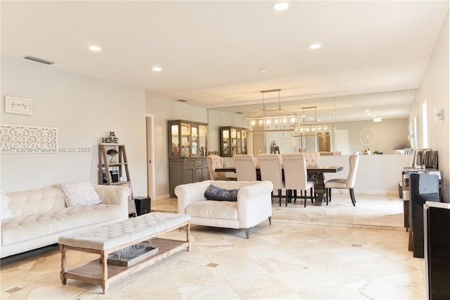 living room with baseboards, visible vents, and recessed lighting