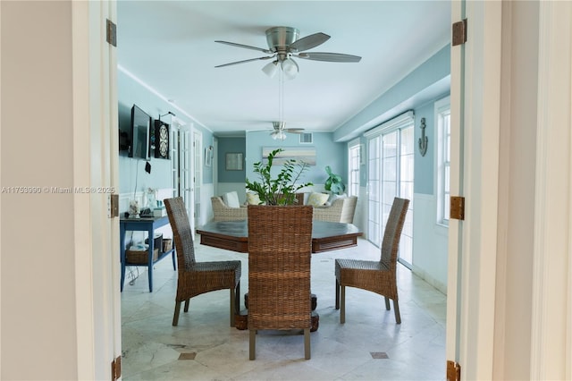 dining area with ceiling fan and visible vents