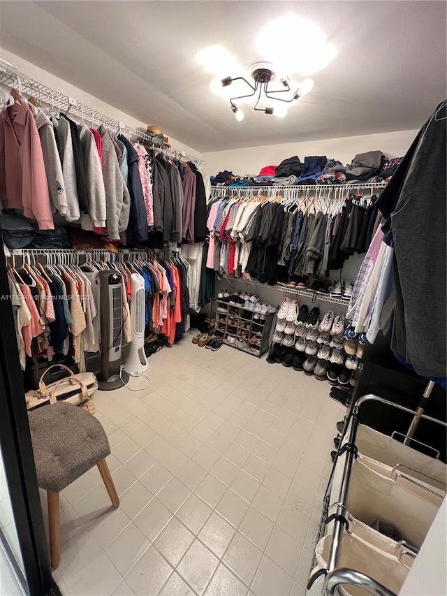 walk in closet with tile patterned floors