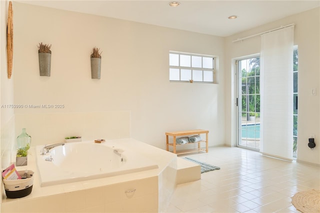 bathroom featuring a garden tub, tile patterned flooring, and recessed lighting