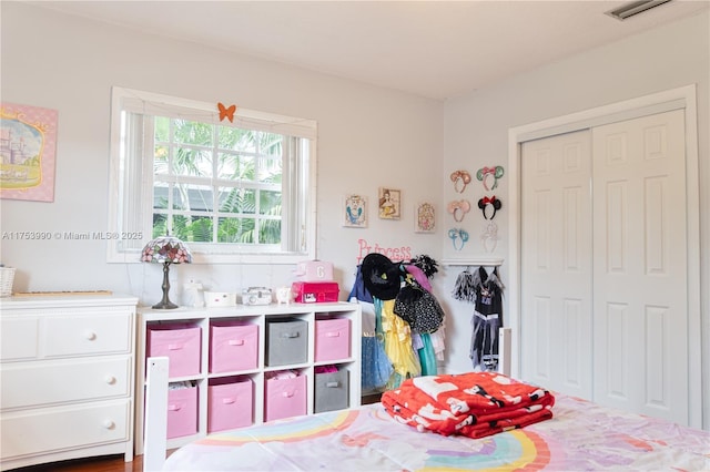 bedroom with a closet and visible vents