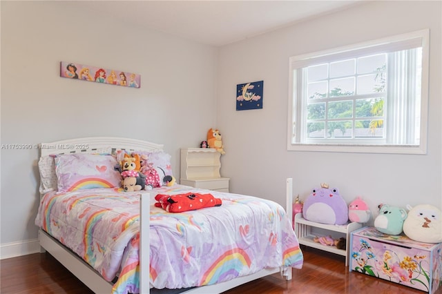 bedroom featuring baseboards and wood finished floors