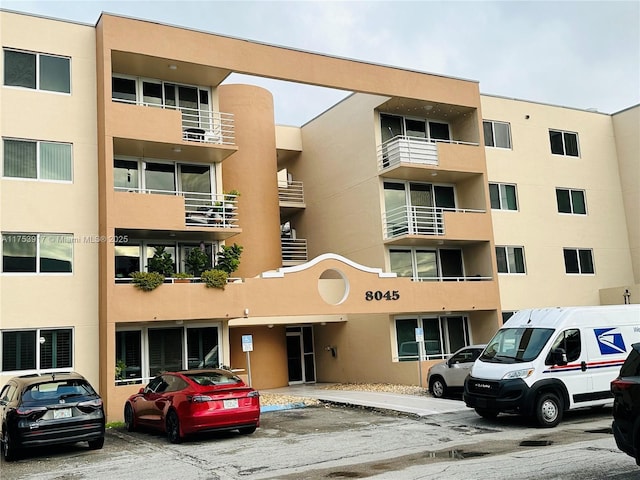 view of building exterior featuring uncovered parking