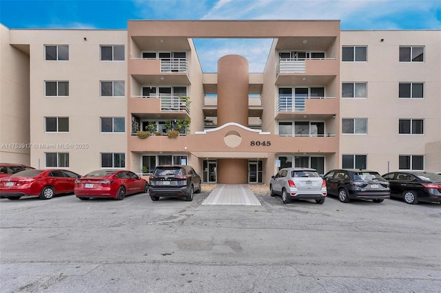 view of building exterior with uncovered parking