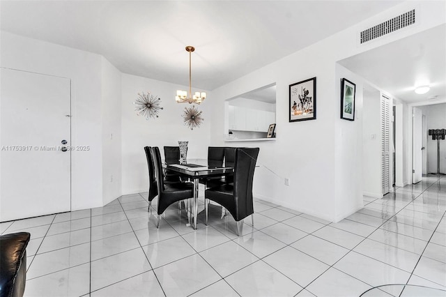 dining room featuring visible vents, a notable chandelier, and light tile patterned floors