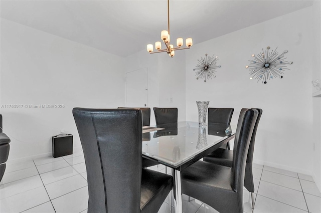 dining space featuring a chandelier, baseboards, and tile patterned floors