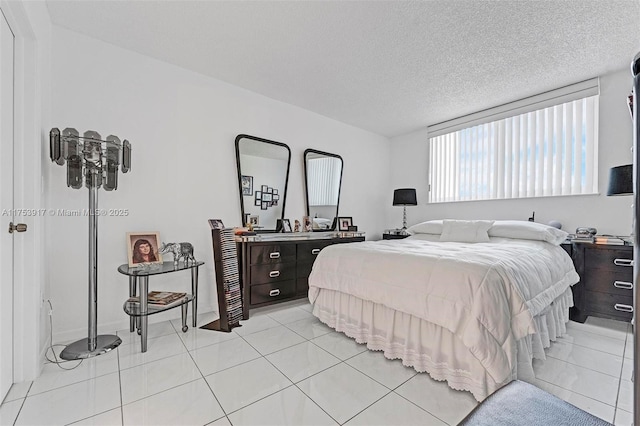 bedroom featuring light tile patterned floors and a textured ceiling