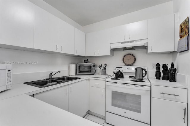 kitchen featuring a toaster, under cabinet range hood, white appliances, a sink, and light countertops