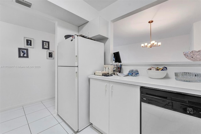 kitchen with white appliances, light tile patterned floors, visible vents, white cabinets, and light countertops