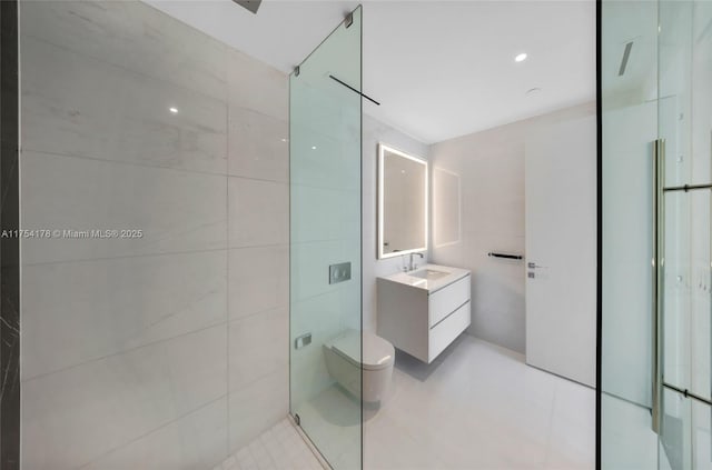 full bathroom featuring tile walls, toilet, a stall shower, vanity, and tile patterned flooring