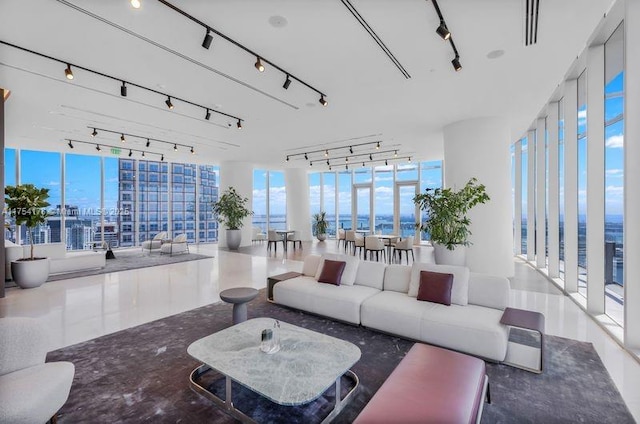 living room with a wall of windows and track lighting