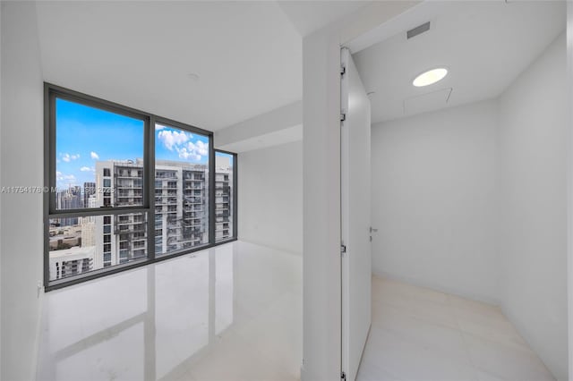 hall with a view of city and visible vents