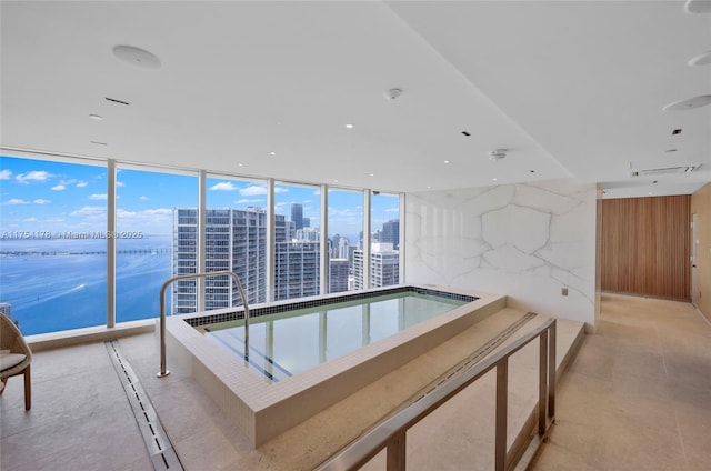 view of swimming pool featuring a jacuzzi and a city view