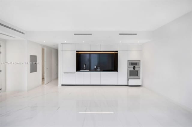 interior space with marble finish floor, a sink, visible vents, and recessed lighting