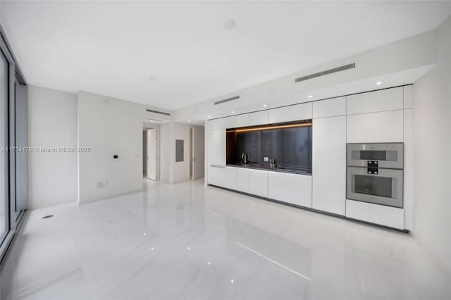 unfurnished living room with marble finish floor and visible vents