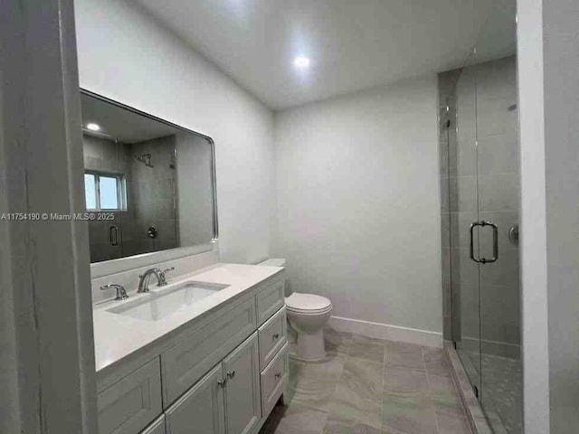 bathroom featuring baseboards, toilet, a stall shower, and vanity