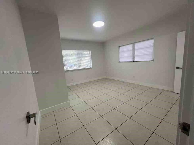 unfurnished bedroom featuring light tile patterned floors and baseboards