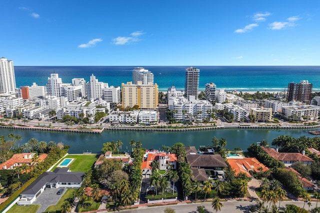 birds eye view of property featuring a water view and a city view