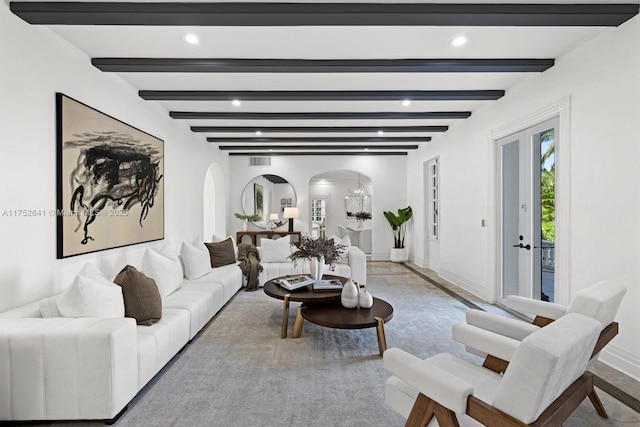 living room with arched walkways, beam ceiling, baseboards, and recessed lighting