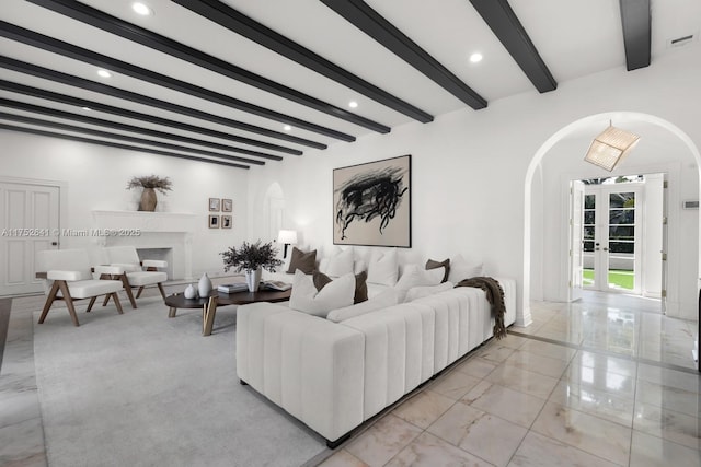 living area featuring arched walkways, marble finish floor, beamed ceiling, and recessed lighting