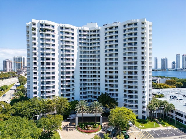 view of property featuring a water view and a view of city