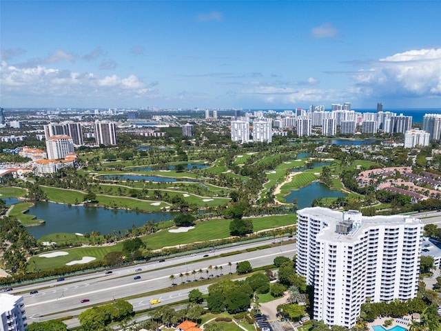 birds eye view of property featuring a water view, a city view, and golf course view