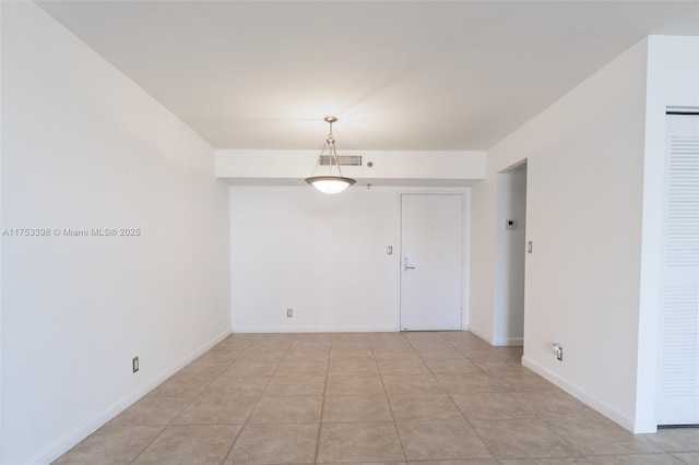 spare room featuring light tile patterned floors, baseboards, and visible vents