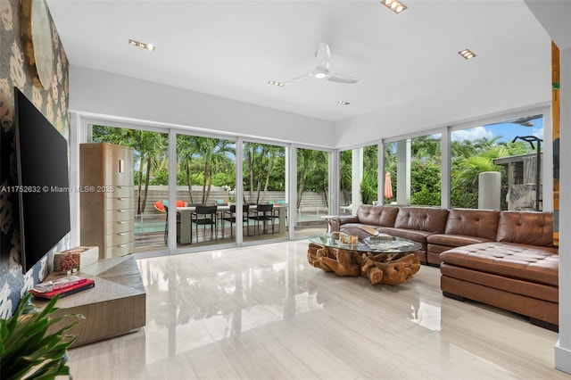 sunroom / solarium featuring ceiling fan