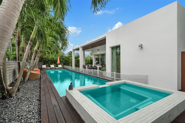 view of pool featuring a fenced backyard, a fenced in pool, and an in ground hot tub