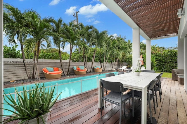 wooden terrace with a fenced backyard, a fenced in pool, outdoor dining area, and a pergola