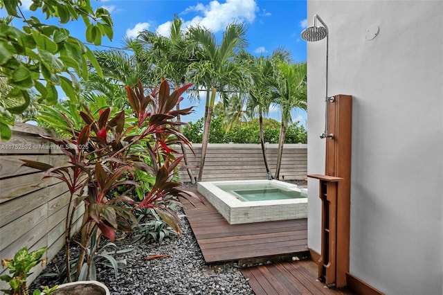 exterior space with an outdoor hot tub