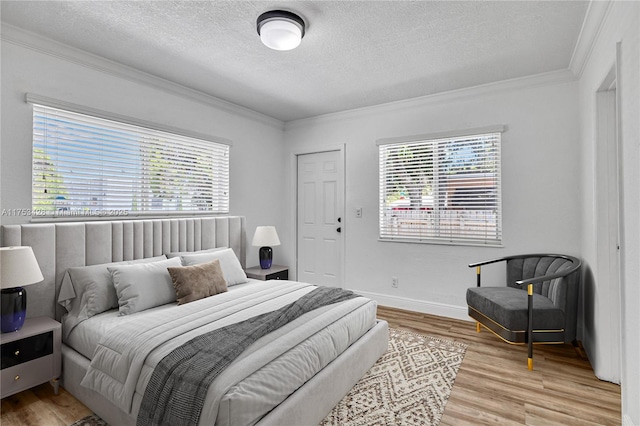 bedroom featuring a textured ceiling, ornamental molding, multiple windows, and wood finished floors