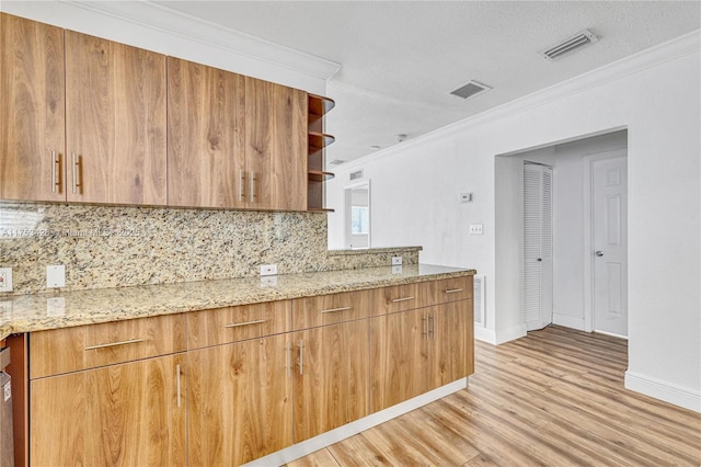 kitchen featuring open shelves, ornamental molding, and visible vents