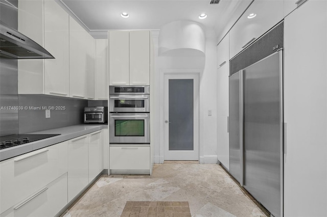 6 Coconut Ln, Key Biscayne, FL 33149 - kitchen with wall chimney range hood, modern cabinets, white cabinets, and stainless steel appliances