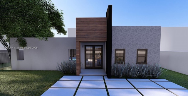 exterior space featuring french doors, a yard, and stucco siding