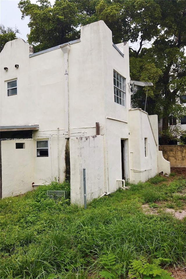 view of side of property with stucco siding