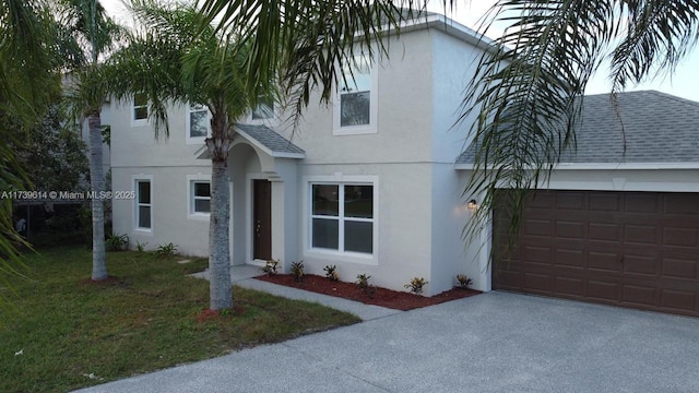 view of front facade with aphalt driveway, a garage, roof with shingles, stucco siding, and a front yard