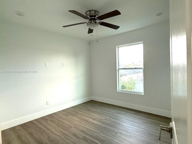 empty room with a ceiling fan, baseboards, and wood finished floors