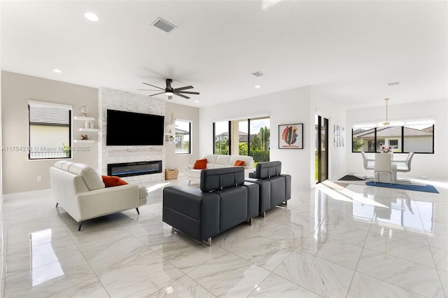 living room with visible vents, ceiling fan, marble finish floor, a fireplace, and recessed lighting