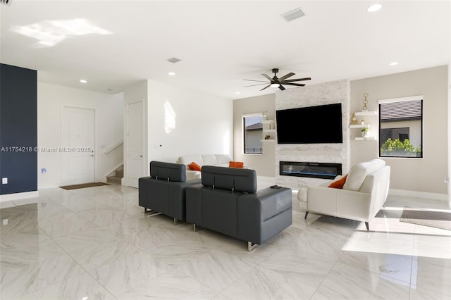 living area featuring marble finish floor, a fireplace, stairway, and recessed lighting