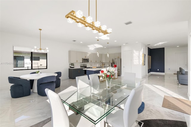 dining room featuring marble finish floor, baseboards, visible vents, and a notable chandelier