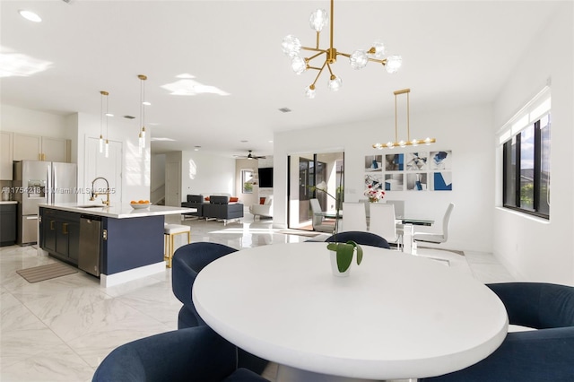 dining room with marble finish floor, a healthy amount of sunlight, recessed lighting, and a notable chandelier