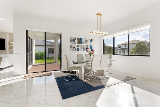 dining space with marble finish floor and a notable chandelier